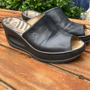 Fly London Black Leather Wedge Mules